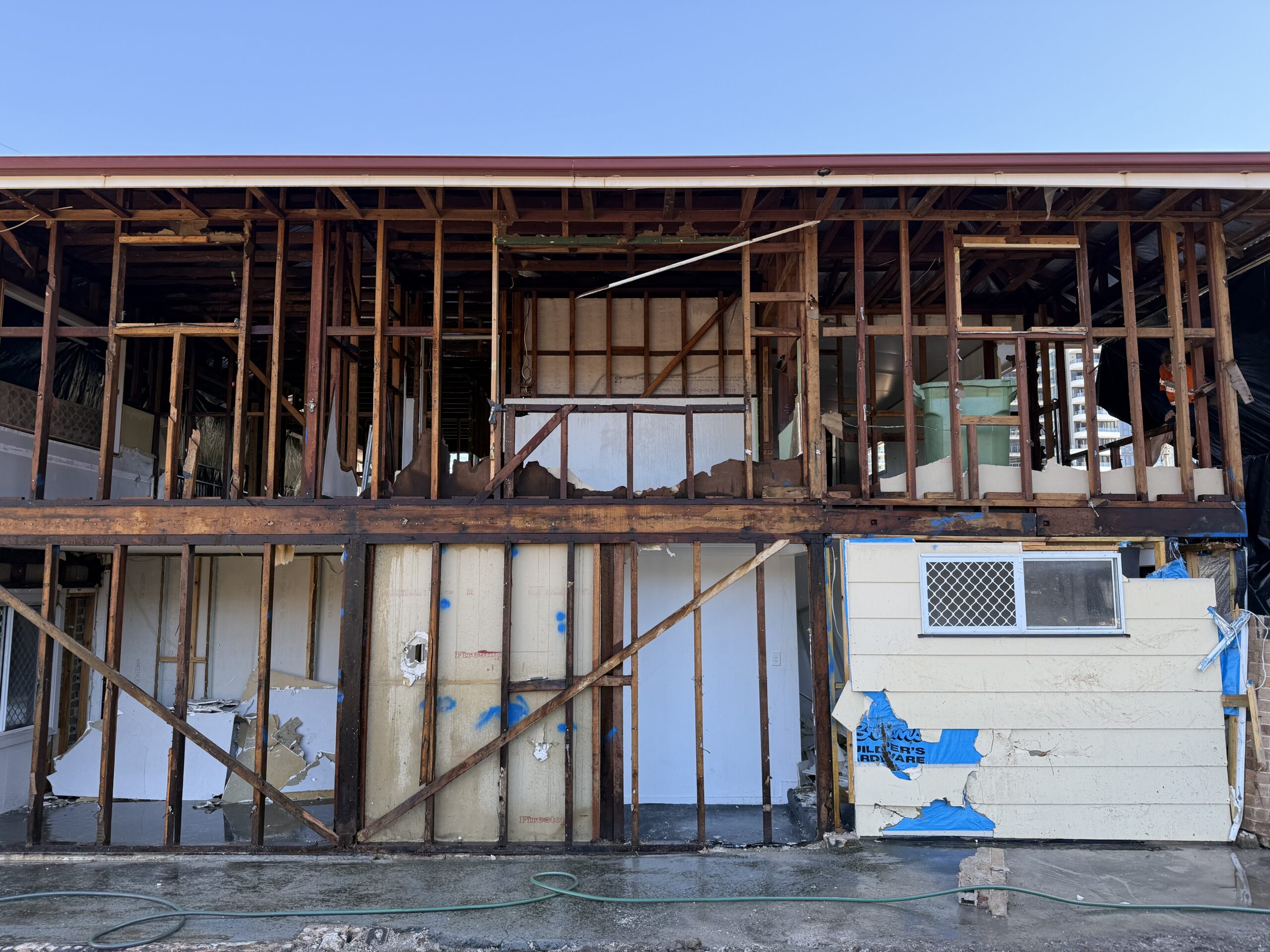 Exterior of a residential building with bonded asbestos cement sheeting removed and stripped back